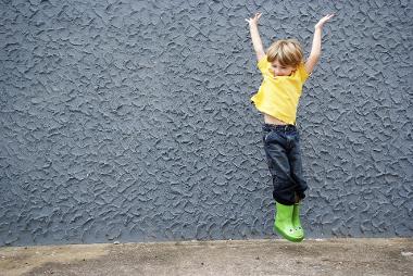 primary school child jumps in the air