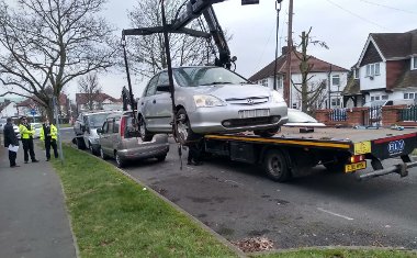 Cars being removed by enforcement officers