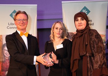 Gemma McCaffery, centre, and Franka Aichour receive their award from Libraries Connected 