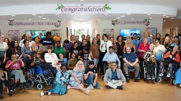 Centre users, their families, and staff past and present celebrate the 10th anniversary of the Queens Walk Resource Centre