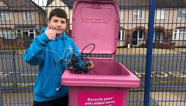 A pink wheelie bin branded for the Cable Challenge recycling competition