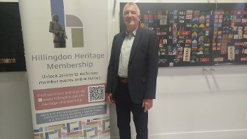 Cllr Eddie Lavery next to the Heritage Membership pull-up banner at the Battle of Britain Bunker